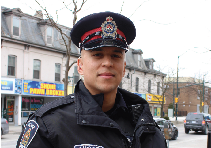 Male officer standing downtown