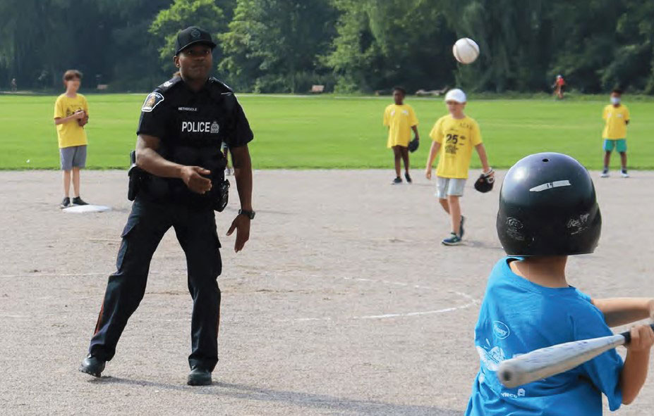 LPS Sergeant throws ball to young batter