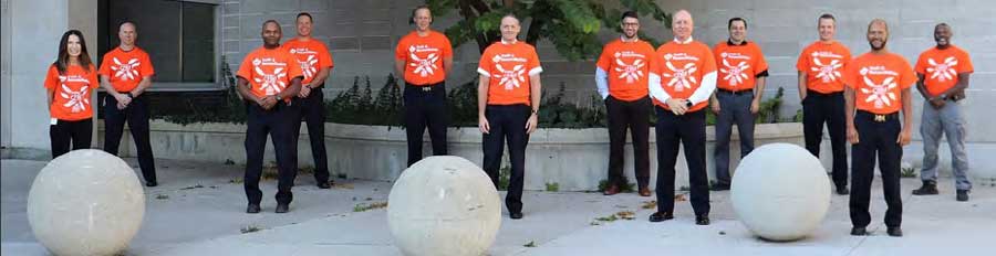 Group photo of LPS members in orange shirts