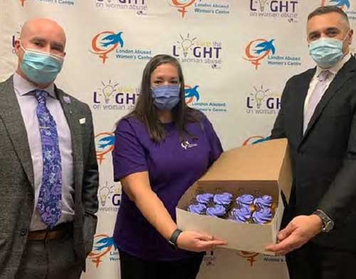 LPS members and LAWC holding box of purple iced cupcakes