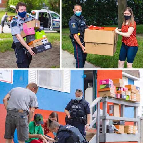 Officers carrying boxes of sneakers in the community