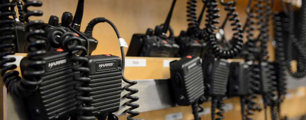 Police communication radios handing on wall