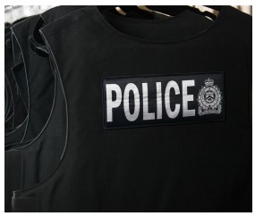 black police bullet proof vest with LPS Logo and words police written in white lettering
