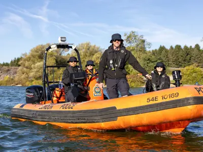 LPS officer in boat on lake