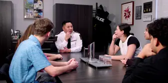 Chief Truong sitting with youth community members