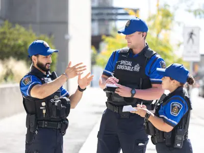 3 Special Constable talking animatedly in front of London Ontario Courthouse