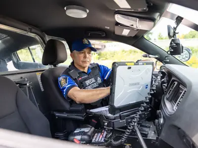 LPS Special Constable sitting in Special Constable Cruiser, working on MDT laptop