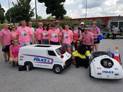 London Pride Parade, wearing pink shirts, mini police cars