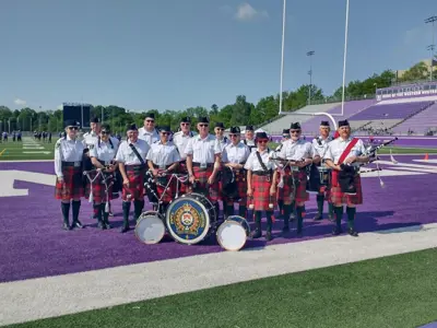 LPS Pipes and Drums on UWO field, ground coloured  purple