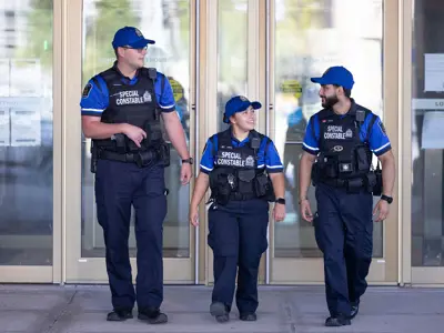 3 Special Constable Walking in front of London Courthouse