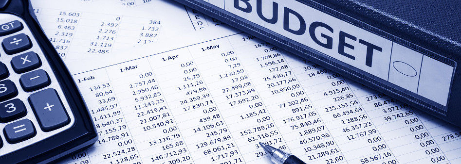 calculator and paper spreadsheet on table