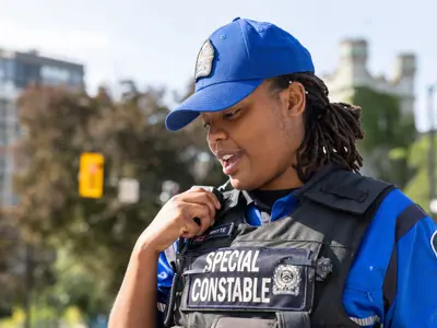 Female Special Constable talking on walkie talkie