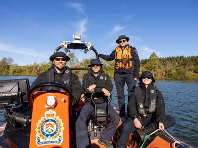 5 officers in LPS marine unit boat - group image