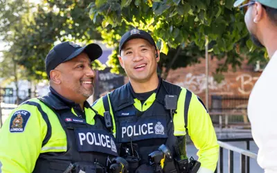 Two officers speaking with citizen on sidewalk