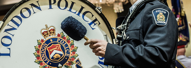 London Police Pipes and Drums - Drummer hitting large drum