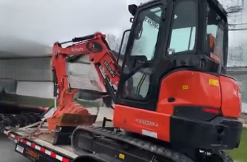 Image of the stolen trailer and excavator