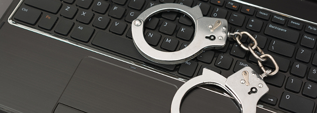handcuffs laying on laptop keyboard