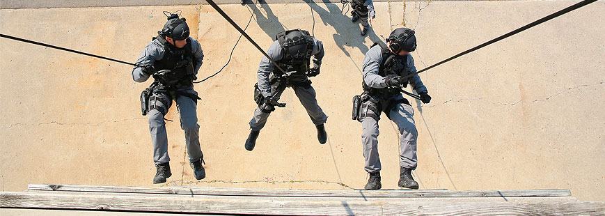Emergency Response Members Rappelling down a wall