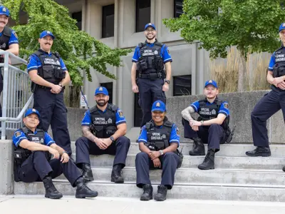 Group photo of LPS Special Constables sitting on LPS Headquarters steps
