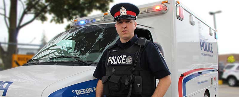 LPS Officer standing in front of LPS paddy wagon