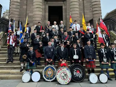 LPS Pipes and Drums, group photo on stairway
