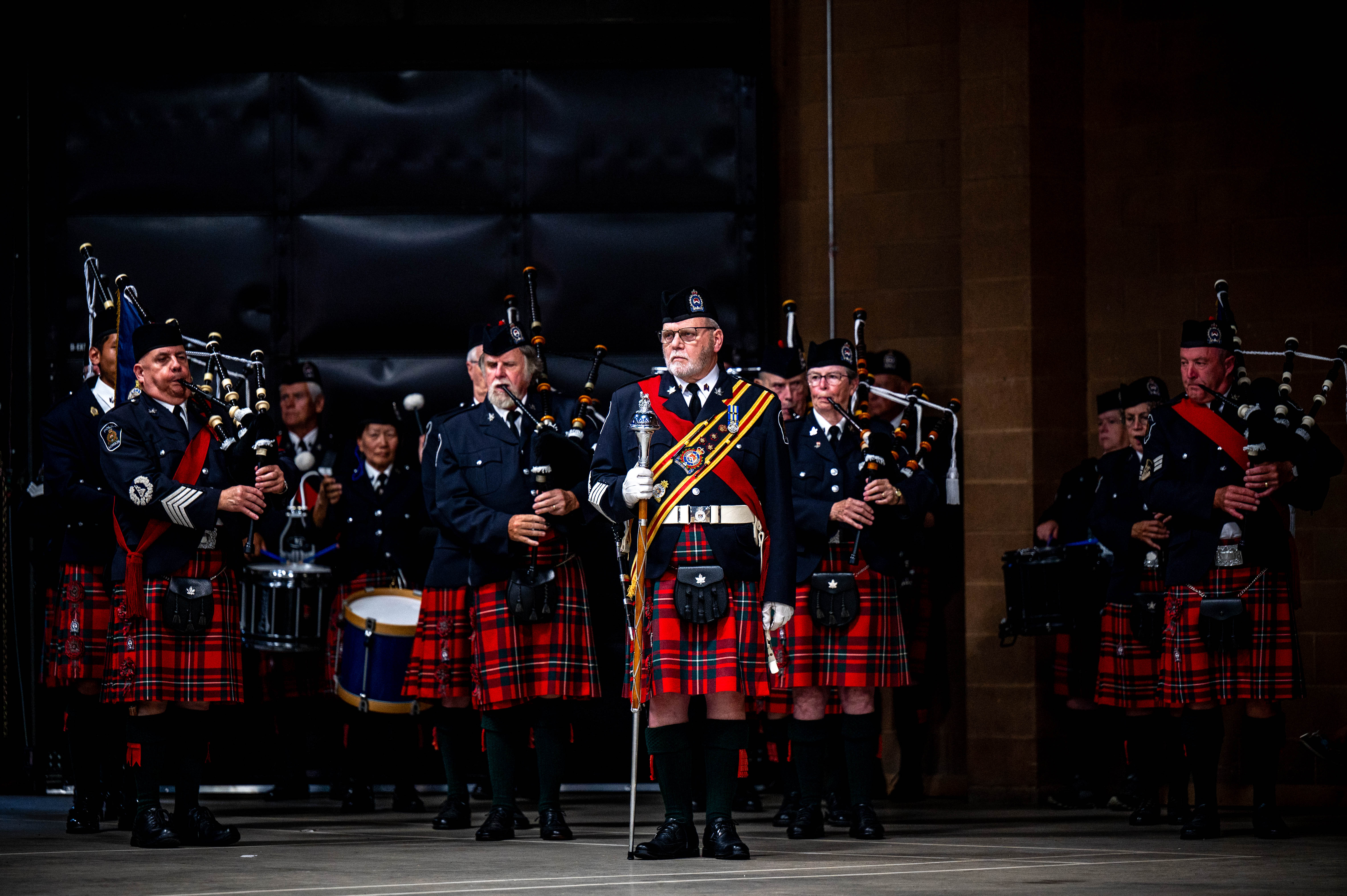 London Police Pipes and Drums standing in formation, instruments ready