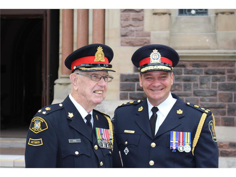 Chief Pare and retired member smiling for photo