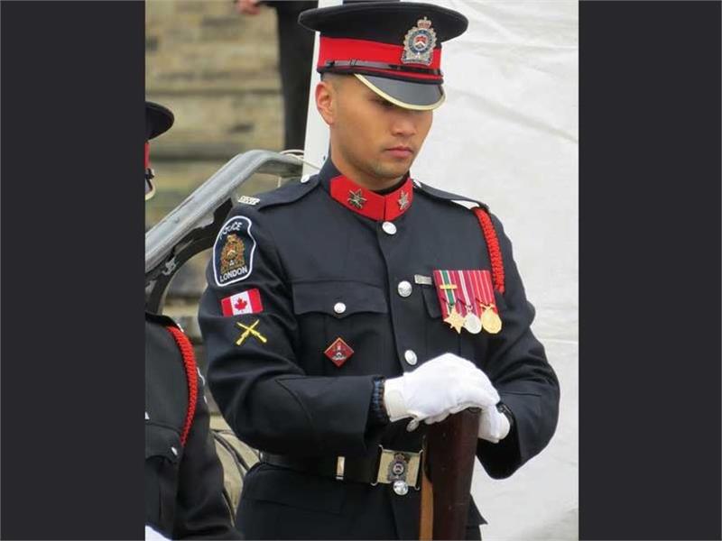 Colour Guard Member gazing downward holding stock of rifle